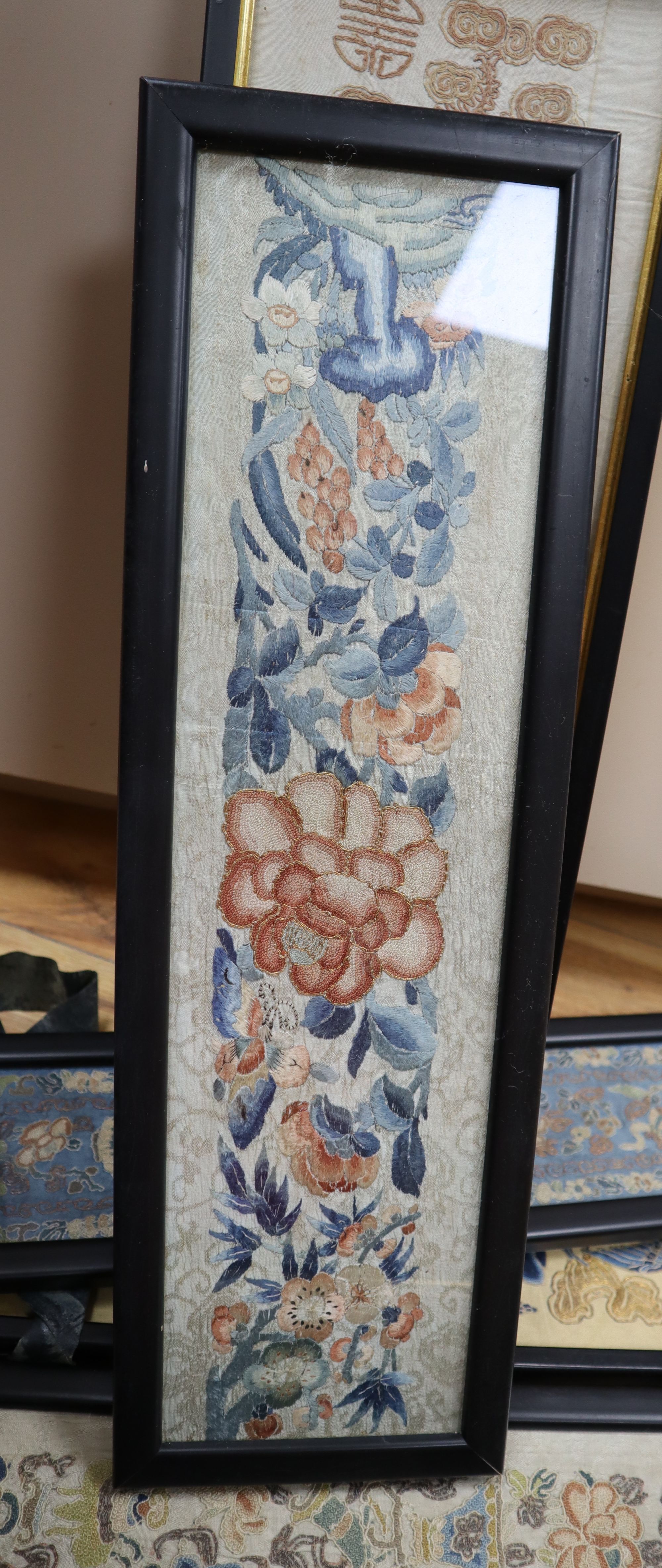 Eleven Chinese embroidered silk sleeve panels, late Qing, framed